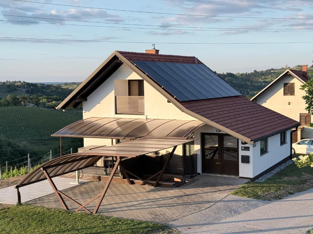 a house with a solar roof on a deck at Liveza House in Miklavž pri Ormožu