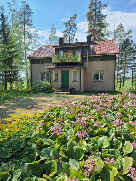 a house with a lot of flowers in front of it at Large detached house without neighbors in Kouvola