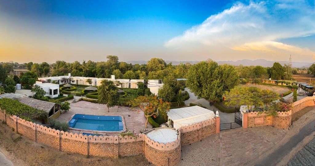 an aerial view of a house with a swimming pool at Haveli Expedition & Resort in Ghānerao
