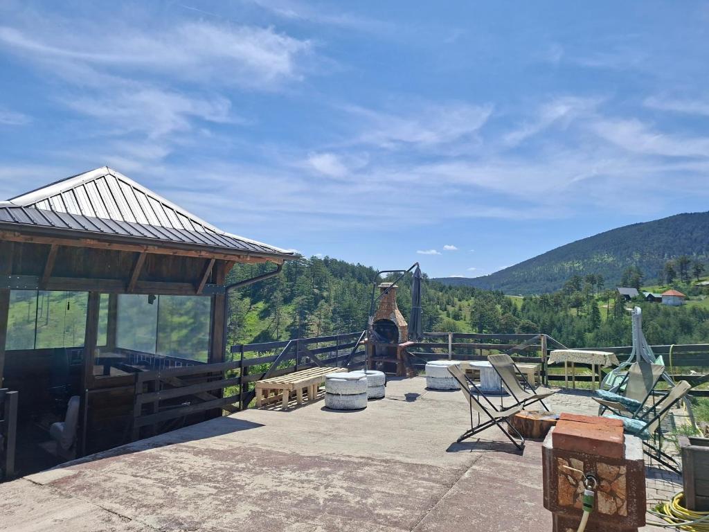 a patio with chairs and a view of the mountains at Ribnica in Ribnica