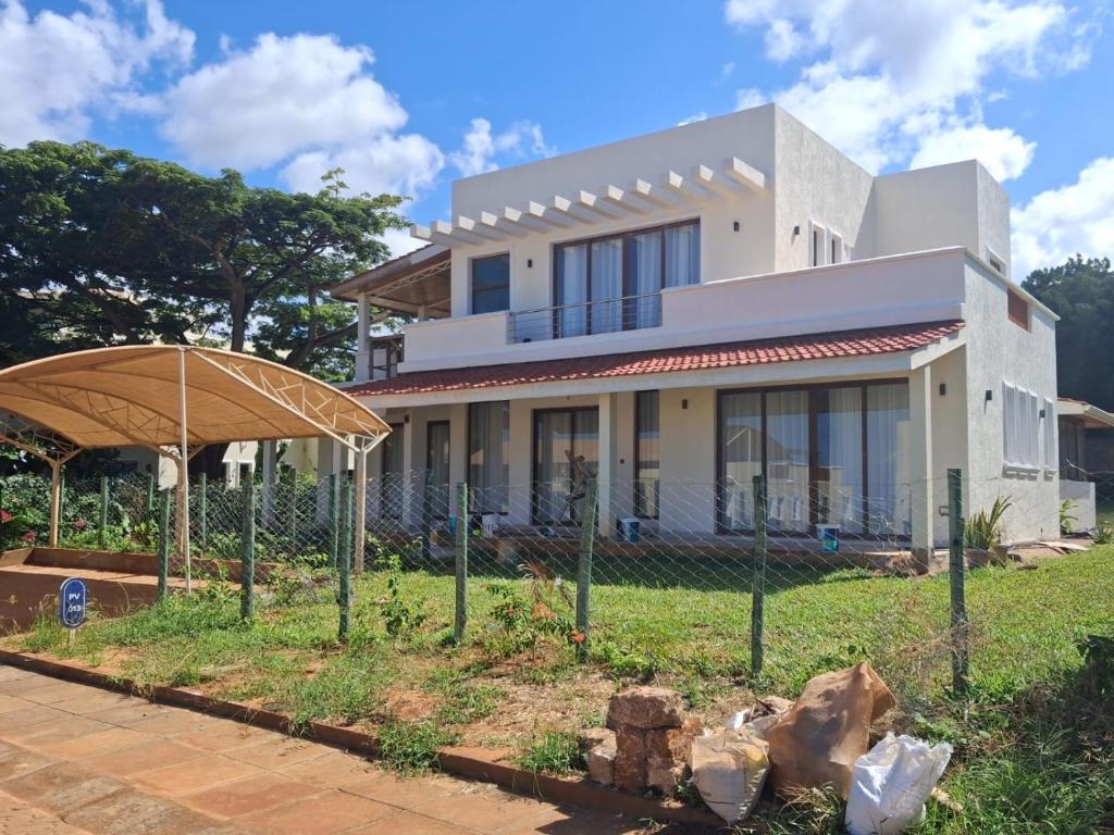 a house with a fence in front of it at Villa in Vipingo in Vipingo