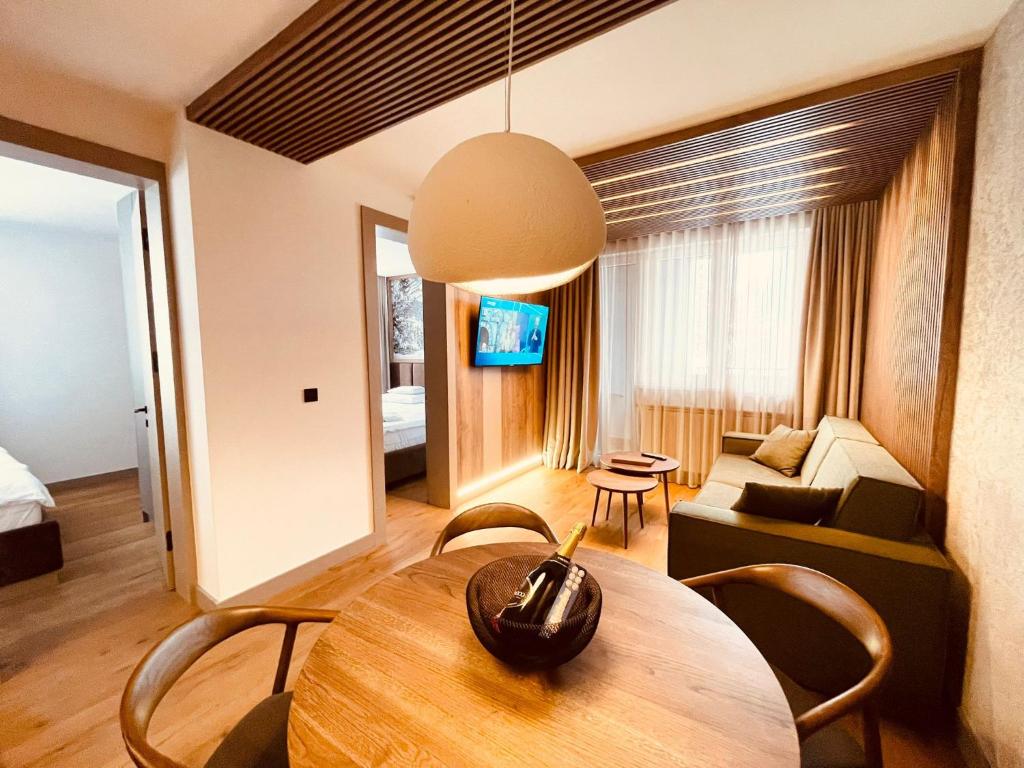 a living room with a table and a couch at Apartman 206 in Jahorina