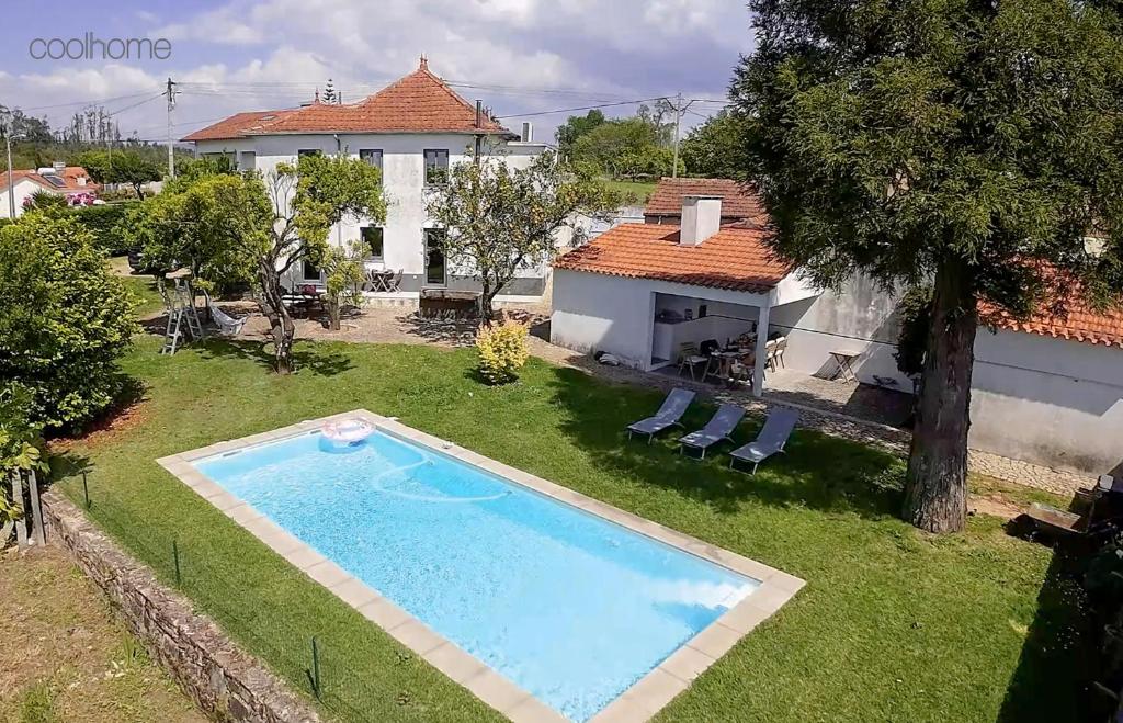 a backyard with a swimming pool and a house at 12 Casa d'Avó in Albergaria-a-Velha