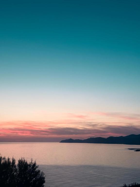a sunset over a body of water at West Sardinia - Bosa in Magomadas