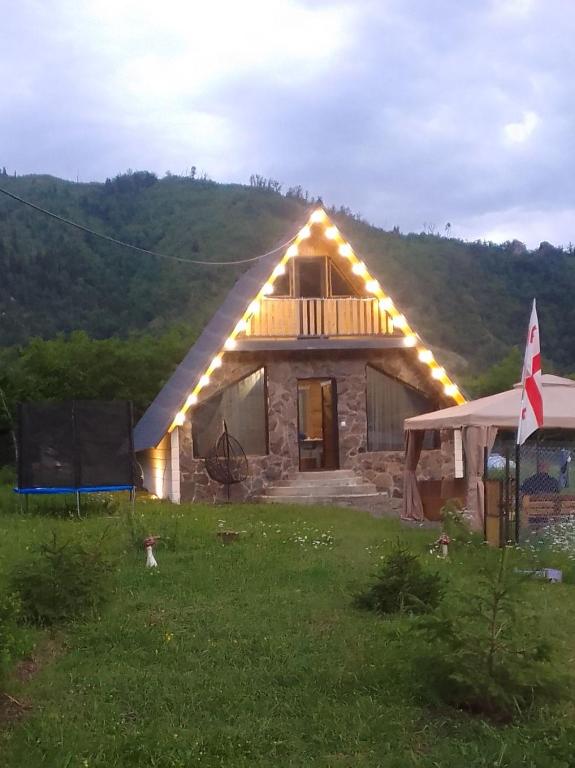 a house with lights on the front of it at Kedari Borjomi Cottage in Borjomi