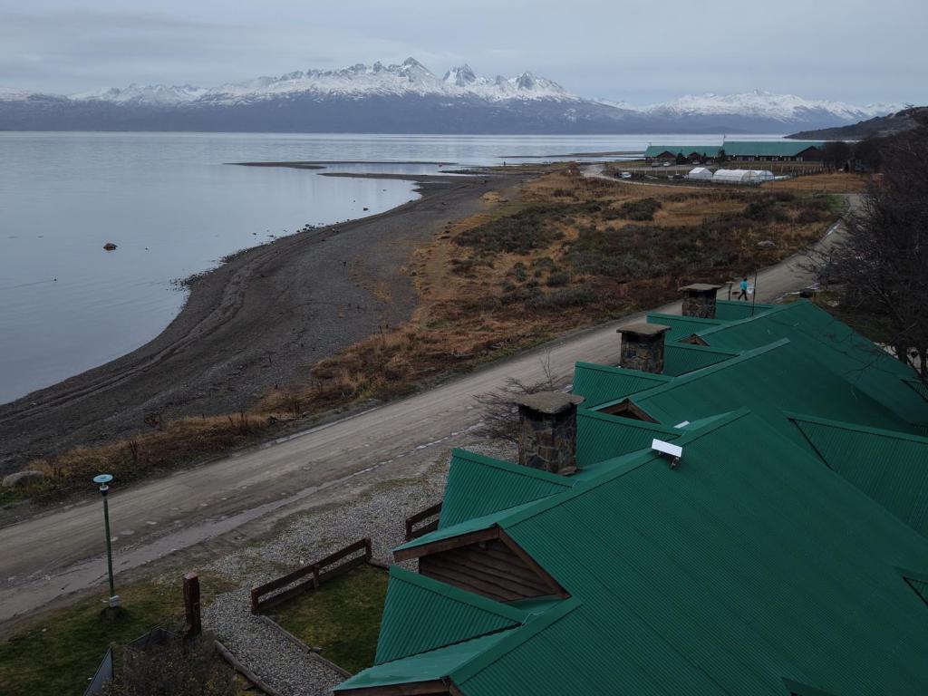 an aerial view of a green building next to a body of water at COSTA DE LOS PAJAROS in Ushuaia