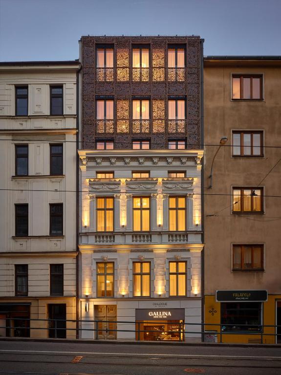 a tall building with many windows on a city street at DIALOGUE Boutique Hotel in Brno