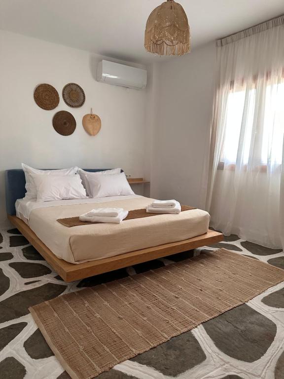 a bedroom with a bed with two towels on it at Villa Ethel Vourvourou in Vourvourou