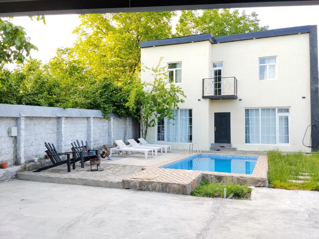 a backyard with a pool and a house at redHome in Gabala