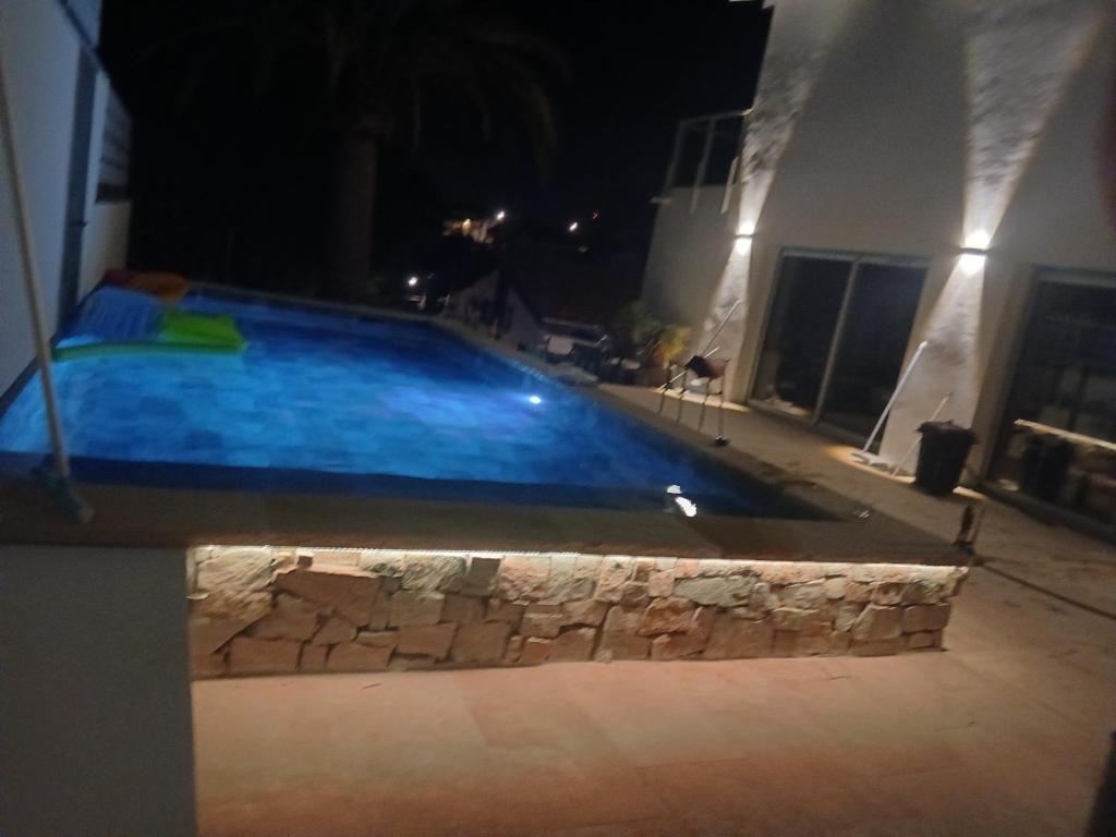 a swimming pool in the middle of a house at night at villa avec piscine in Hendaye