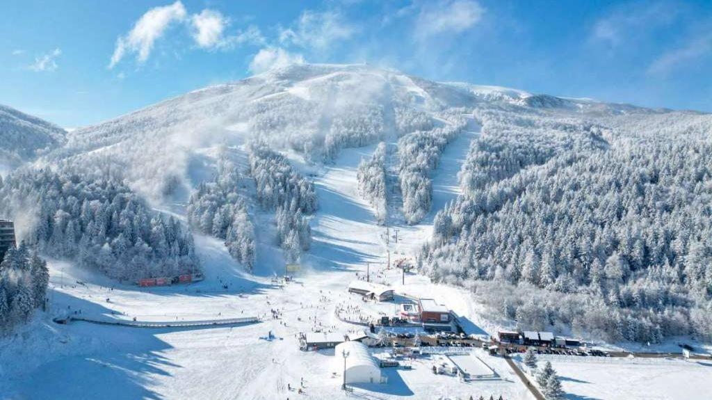 a snow covered mountain with a ski resort on it at Bjelašnica Escape in Bjelašnica