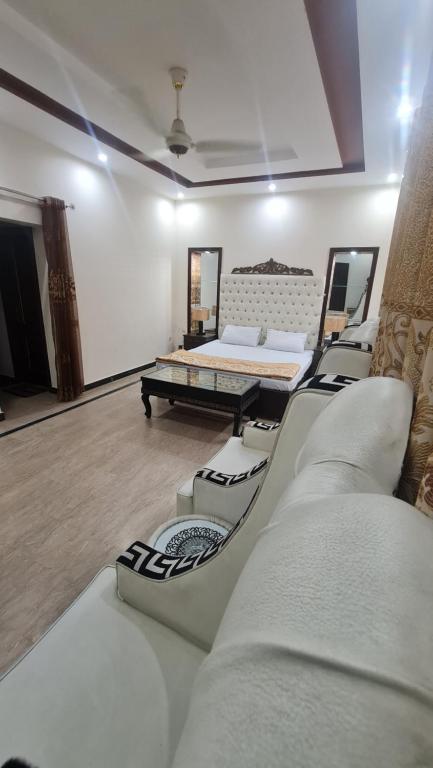 a living room with a couch and a bed at Classy home in Lahore
