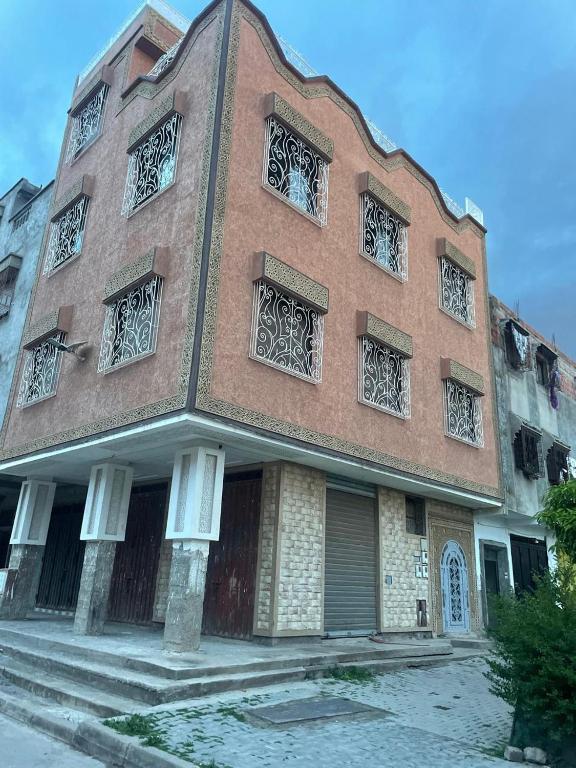a large brick building with many windows on it at marrakesh Big house in Marrakesh
