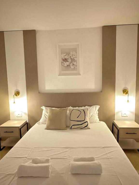 a bedroom with a bed with two towels on it at Sunrise house apartments in Ulcinj