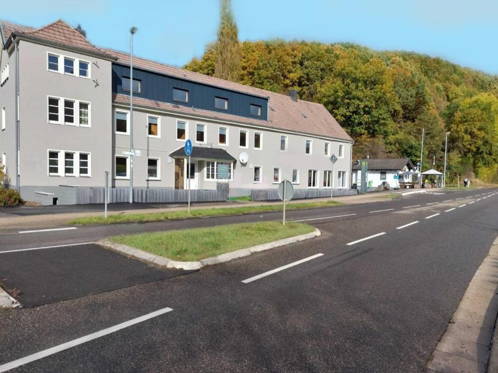 a white building on the side of a street at Eifel Nationalpark Grand Lodge in Schleiden