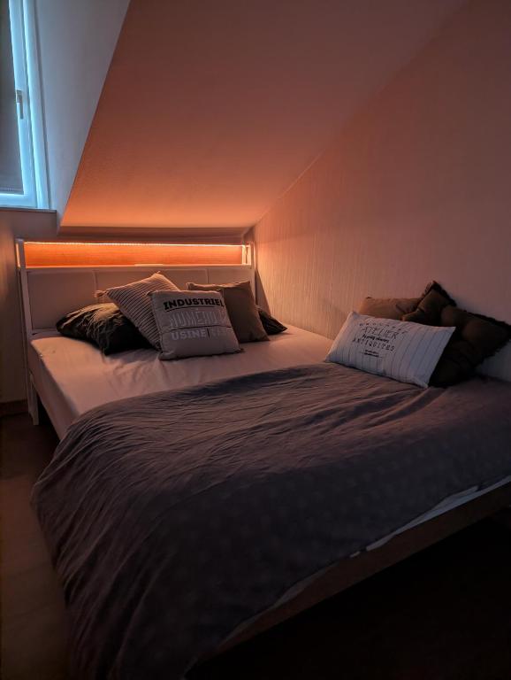 a bedroom with two beds with pillows on them at L'industriel in Sarreguemines