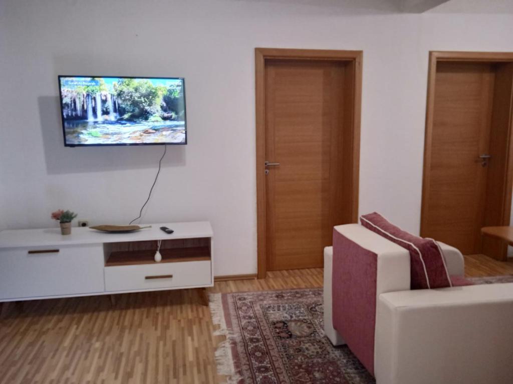 a living room with a couch and a tv on the wall at Ilidza Heart of the nature by Armin in Slivlje