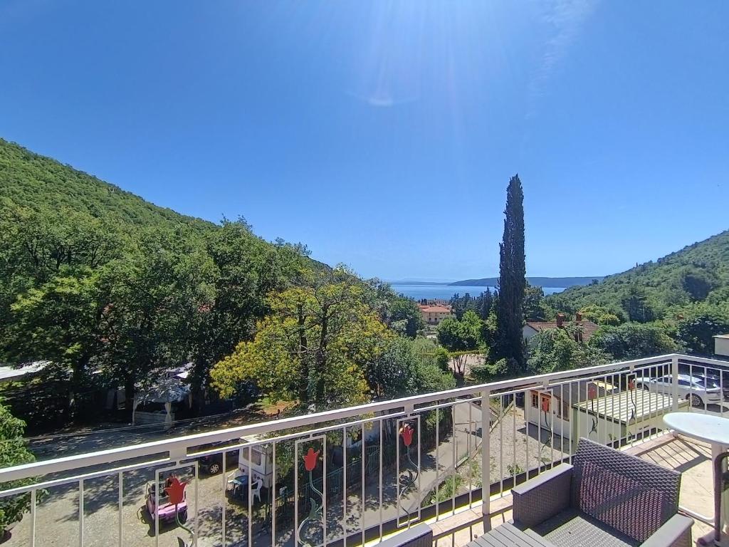 a balcony with a view of a mountain at Apartments Valter Frankovic in Mošćenička Draga