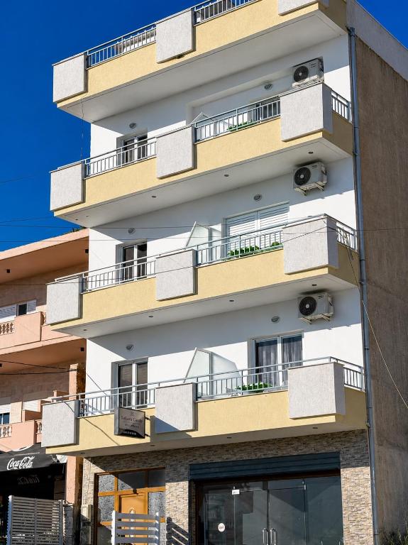 a building with balconies on the side of it at Lukova Center Sunset Apartments in Lukovë