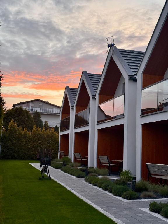 a building with a sunset in the background at Nowa Stodoła in Władysławowo