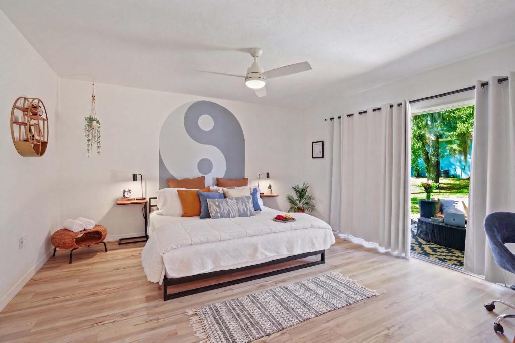 a bedroom with a large bed and a large window at The YinYang - King Bed , Workspace , Full Kitchen in Gainesville
