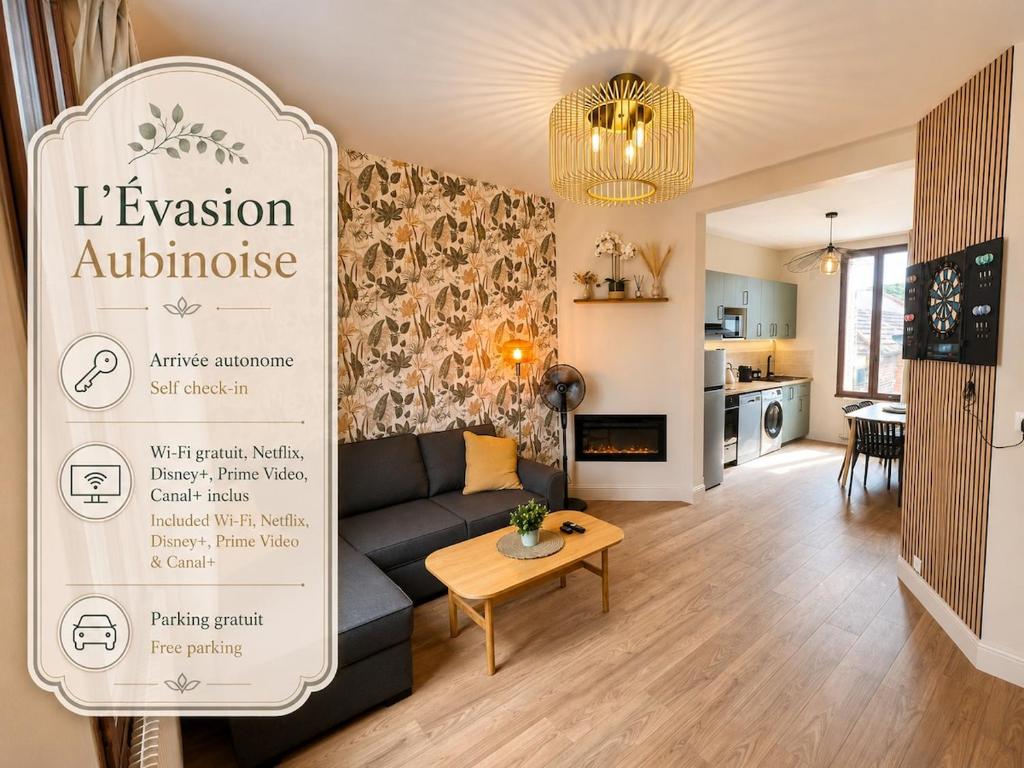 a living room with a couch and a sign for an apartment at Évasion Aubinoise, charmant duplex in Saint-Aubin-lès-Elbeuf