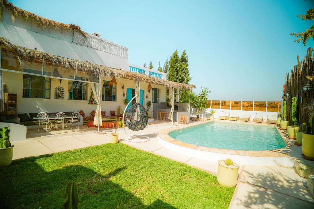 a house with a swimming pool in the yard at Villa Aloe Vera Privée in Essaouira