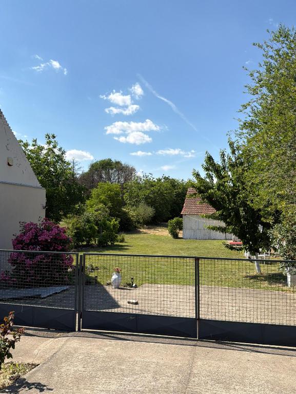 a person sitting on the ground behind a fence at Moja Vojvodjanka in Gornja Rogatica