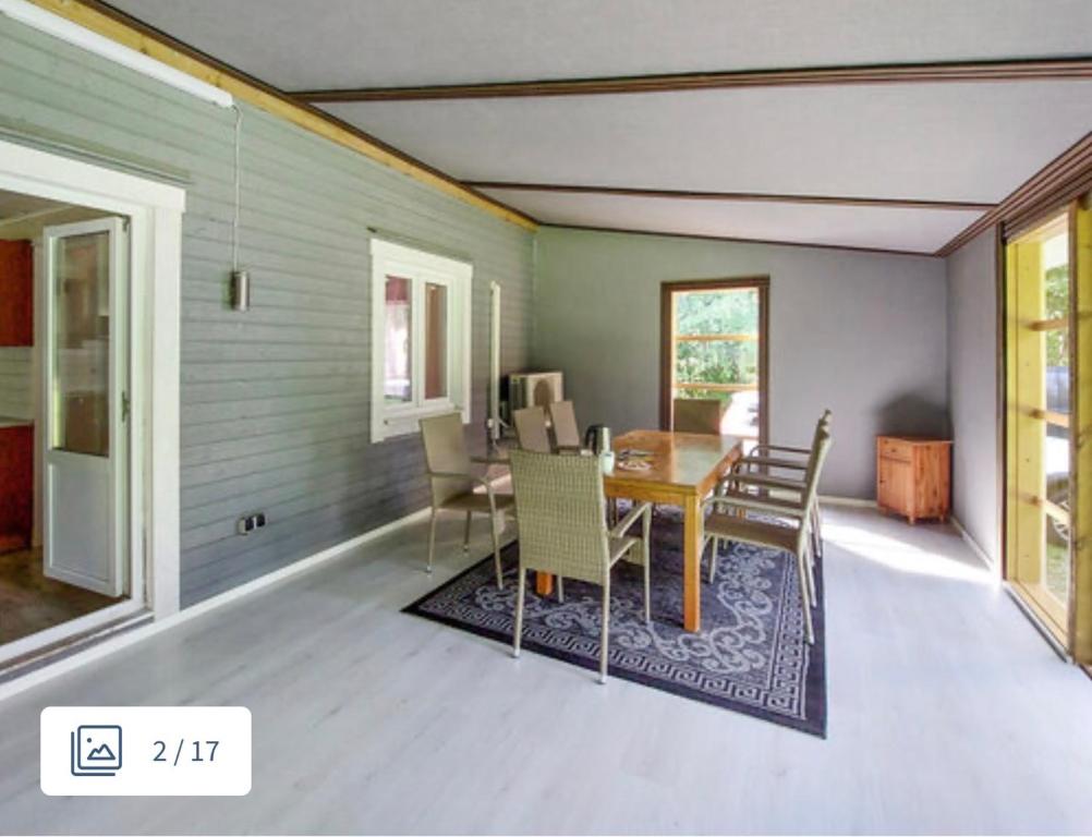 a dining room with a table and chairs at Grå villa in Vislanda