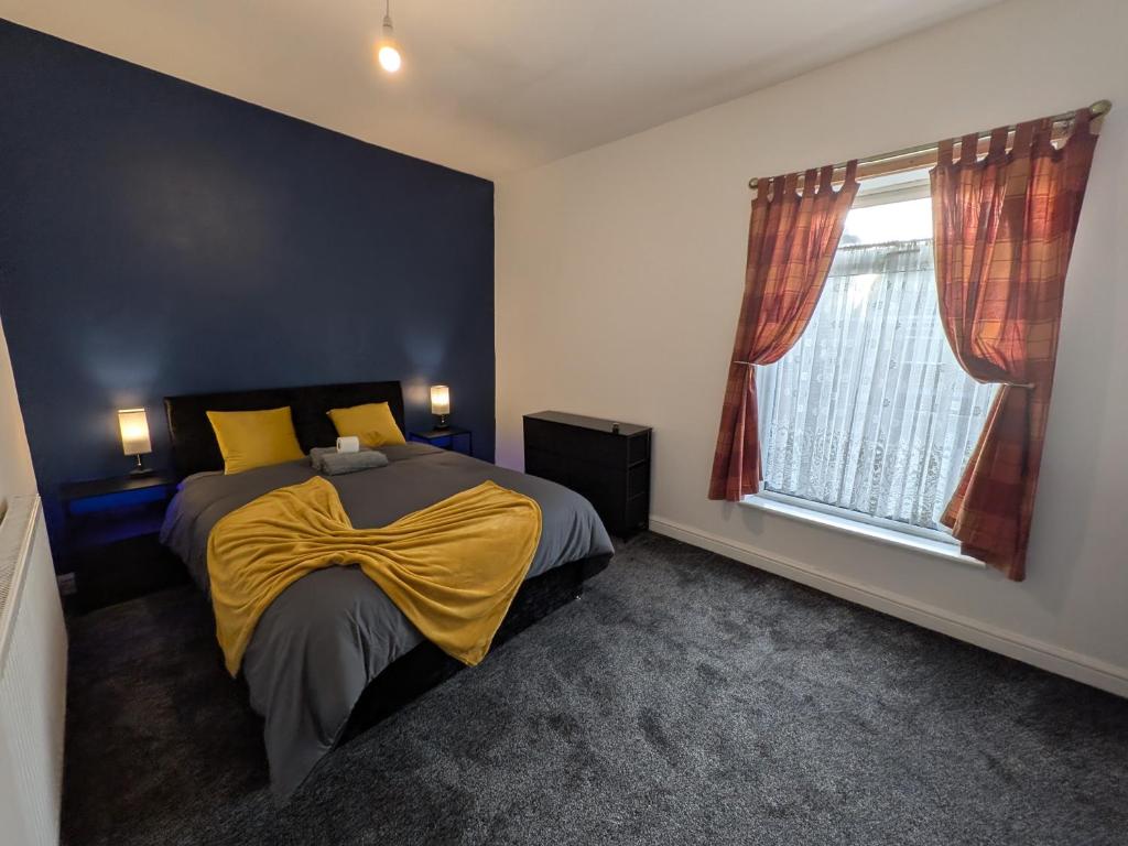 a bedroom with a bed with a yellow blanket on it at Stay Sleep Rest - Cranbrook in Doncaster