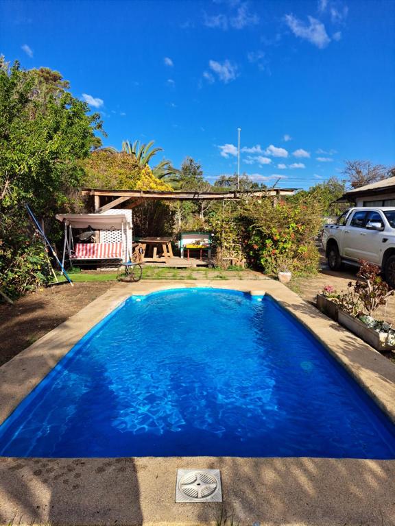 a blue swimming pool in the backyard of a house at Geranio Bed & Breakfast in Casablanca