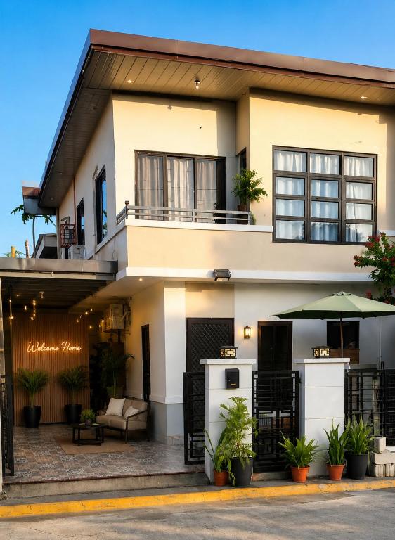 a large white house with an outdoor patio at The Lake Haus Cebu in Lapu Lapu City