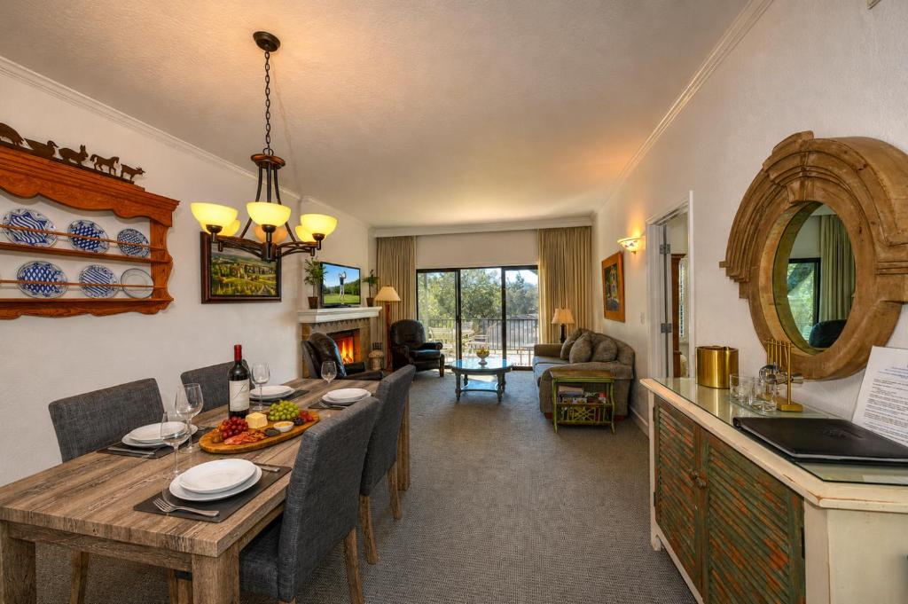 a kitchen and living room with a table and chairs at Spacious 2BR condo with pool, fireplace,at Silverado Country Club in Napa