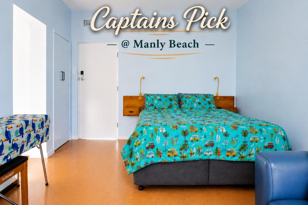 a bedroom with a bed with a blue comforter at Captain's Pick at Manly Beach plus Parking in Sydney