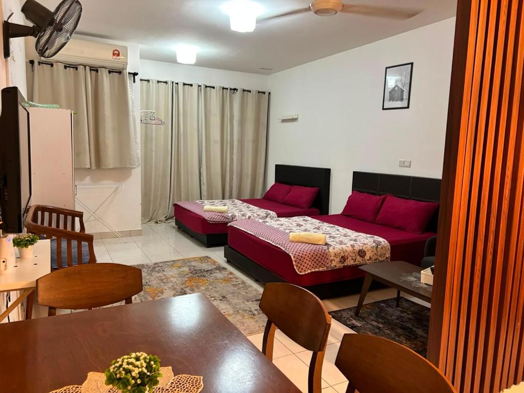 a living room with a bed and a couch at Sara Staycation in Kajang