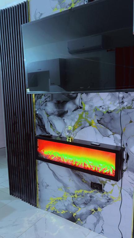 a television screen with a red and green light at Escape casa Ja in Portmore