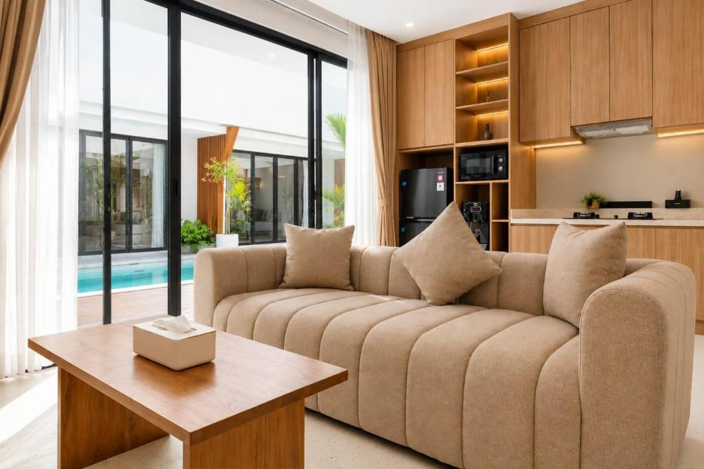 a living room with a couch and a table at Hotel K Seminyak in Badung