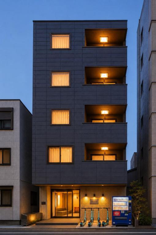 a tall black building with lights on it at Sugamo Winco Residence 新宿まで電車14分 巣鴨駅徒歩3分 光wifi エレベーター 商店街徒歩4分 in Tokyo