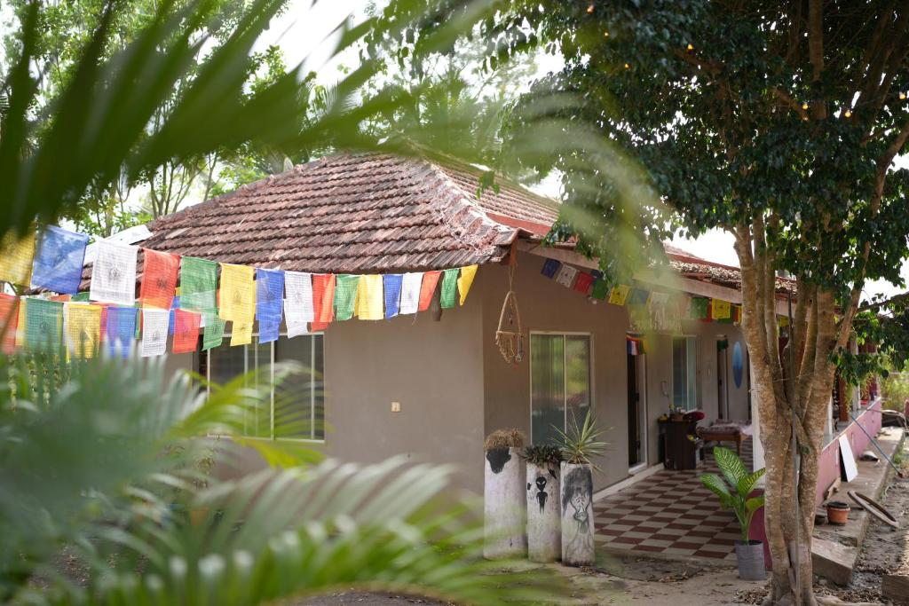 a house with prayer flags on the front of it at Secret Ashram Coorg in Kushālnagar