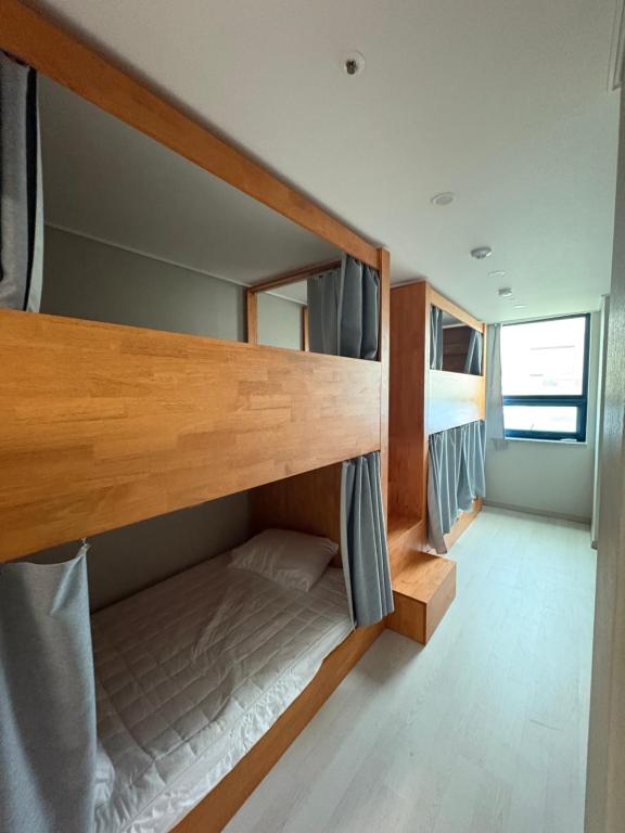 a bedroom with bunk beds in a tiny house at Hostel K wave Only Female Hongdae in Seoul