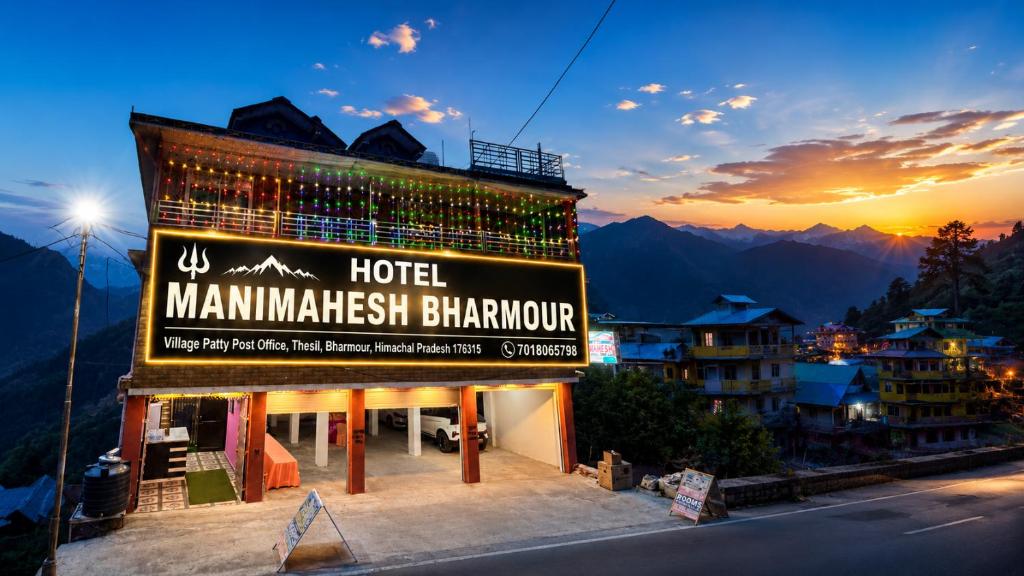 a hotel with a sign on the side of it at Hotel Manimahesh Bharmour in Brāhmaur