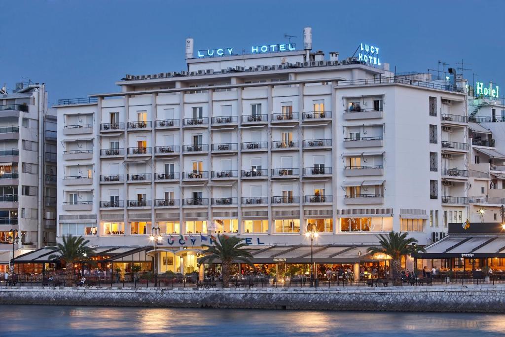 a large white building next to a body of water at Lucy Hotel in Chalkida