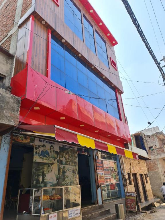 a building with a red and yellow awning at hotel shiv bliss inn Dibai in Dibai
