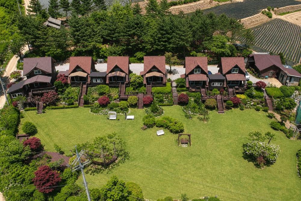 an aerial view of a house on a green lawn at Pyeongchang Estrella Pension in Pyeongchang