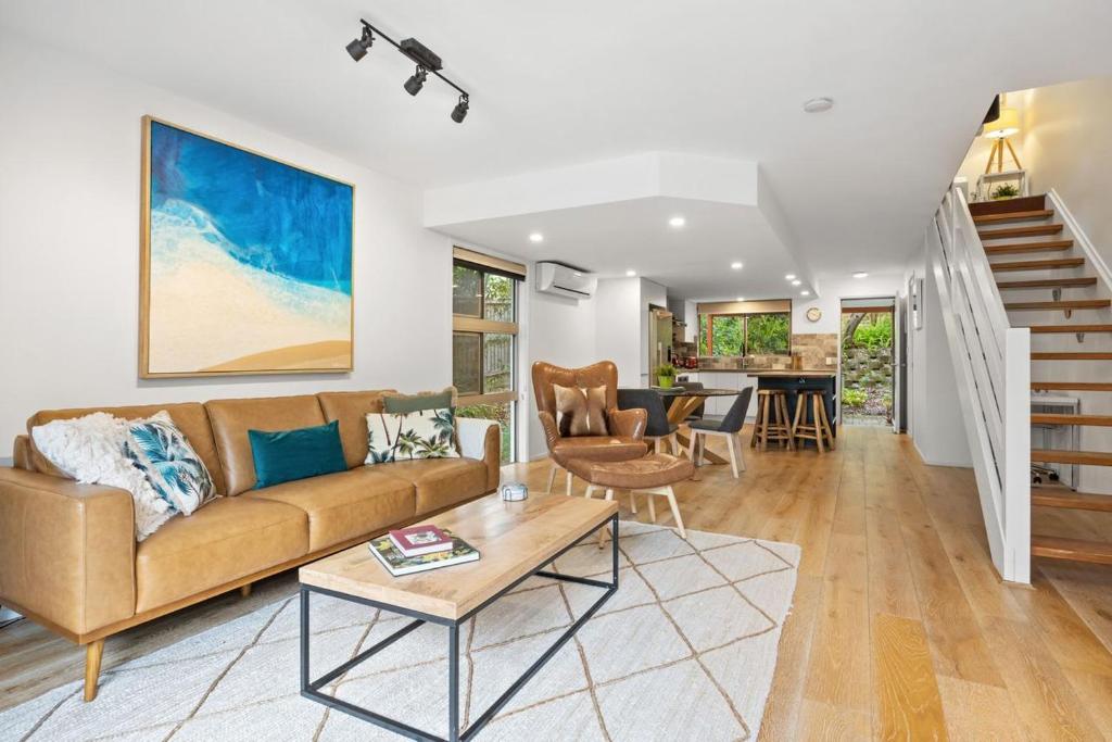 a living room with a couch and a table at Peregian Beach Apartment in Peregian Beach