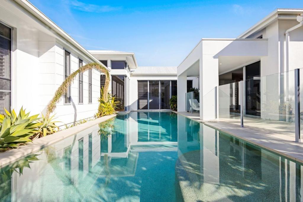an image of a swimming pool in a house at Hampton Beach House on the Waterfront in Buddina