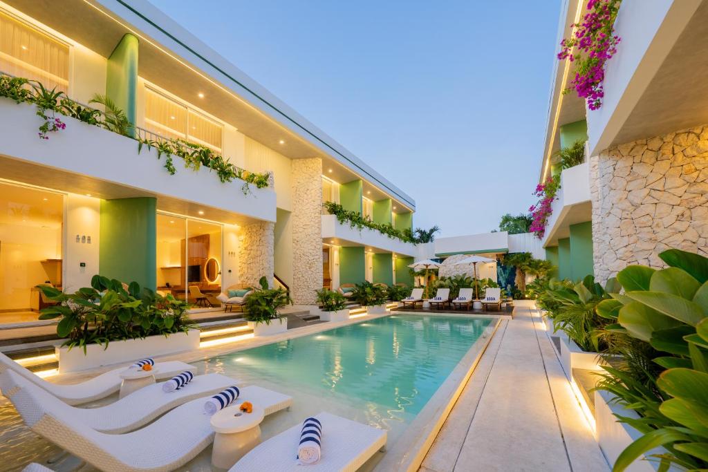 an exterior view of a hotel with a swimming pool at Lomo Boutique Hotel & Villas, Uluwatu in Uluwatu
