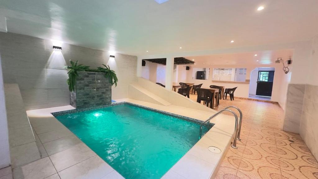 a swimming pool in a house with a dining room at Hostal Maravilla Amazónica in Iquitos