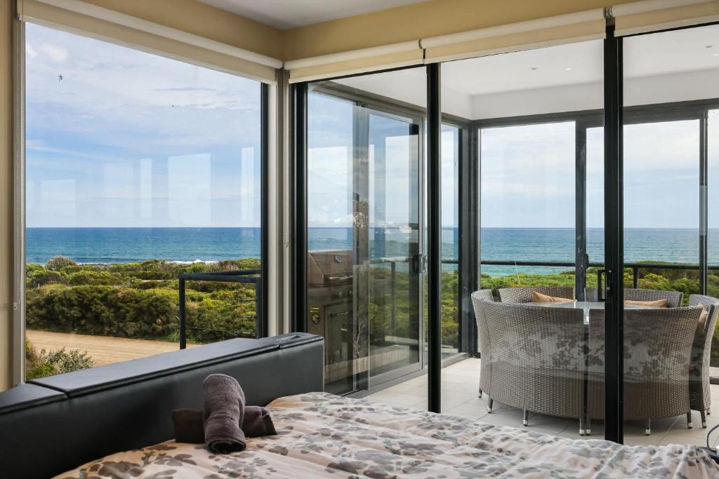 a bedroom with a bed and a view of the ocean at Amazing Ocean Views with Spa in Surf Beach