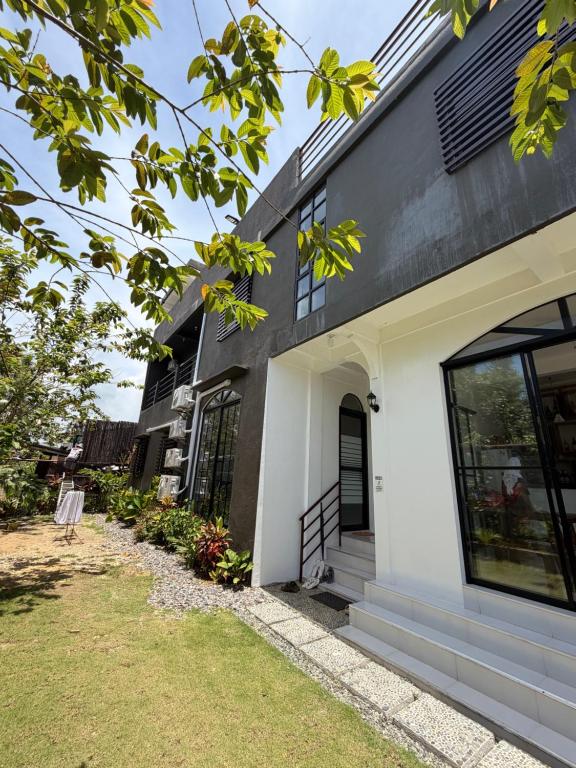 a house with a white and black facade at NOGS Homestay, near Magpupungko, Siargao Island Surfings Spots in Pilar
